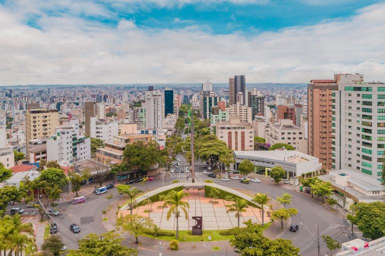 Vista aérea da Praça da Bandeira, localizada na Avenida Afonso Pena.. A imagem mostra a praça em formato circular, com várias árvores, prédios em torno e a cidade ao fundo.
