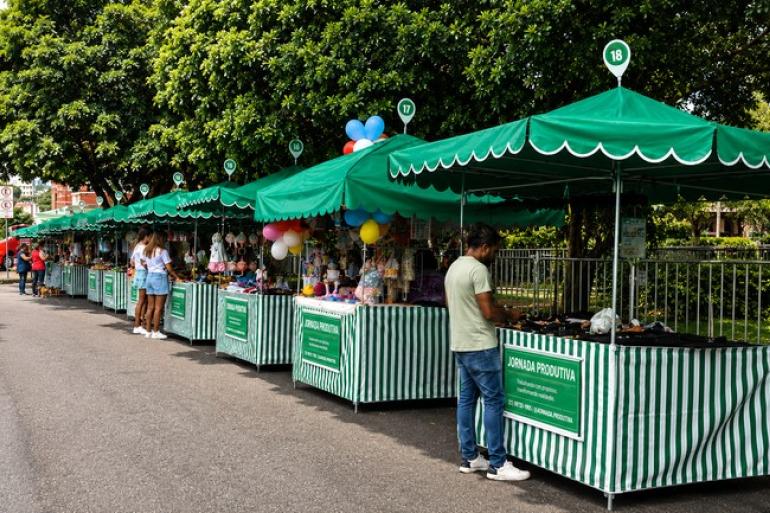 Mais de 800 licenças do Programa Jornada Produtiva devem ser renovadas até o final do ano Foto com barracas nos tons verde e branco, com o escrito Jornada Produtiva
