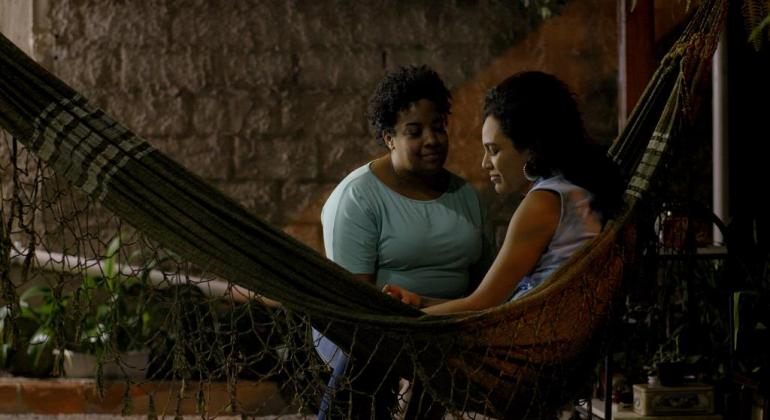 Mostra no MIS Santa Tereza exalta obras de cineastas da periferia de BH Imagem traz duas mulheres conversando, uma sentada em uma rede e a outra de frente para ela.