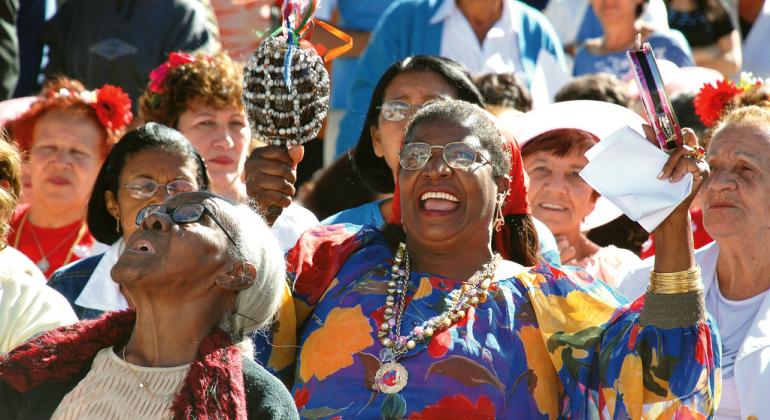 Grupo de mulheres está em rua durante dia de sol