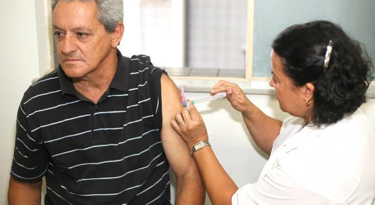 HOmem toma vacina antirábica humana ministrada por agente de saúde. 