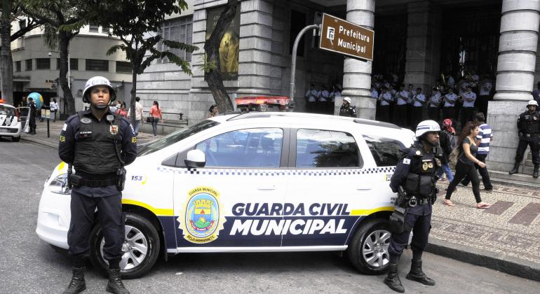 Dois guardas municipais à frente de carro da nova frota em frente à Prefeitura de BH.