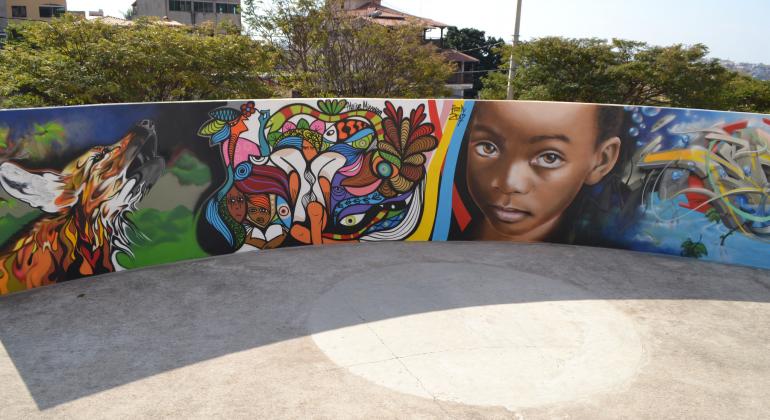Obras em grafite no Centro Cultural Urucuia revelam o olhar de artistas e da comunidade sobre a região do Barreiro. Foto: Kátia Gaspar/PBH Muro do Centro Cultural Urucuia mais quatro tipos de desenho em um grafite e detalhes como: um lobo, uma criança negra com olhos grandes e expressivos, além de desenhos abstratos.