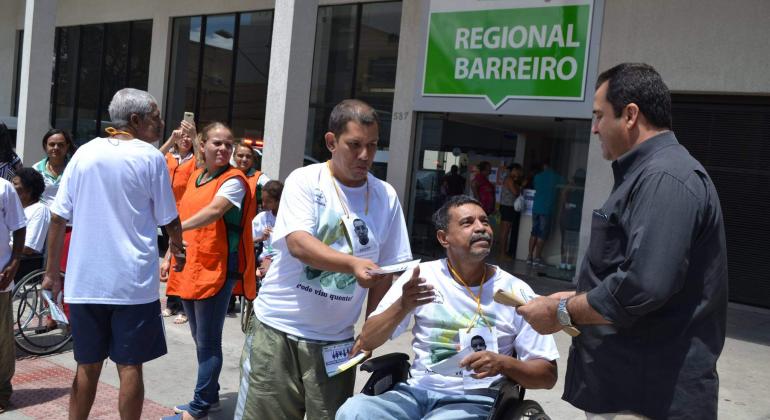 Foto: Divulgação PBH Cadeirante interage com dois homem na frente do Centro Dia Barreiro.