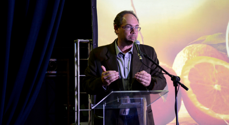 Vice-prefeito Paulo Lamac, palestrando, de pé.