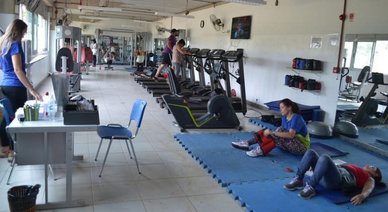 Esteira, bicicleta e alteres são alguns dos aparelhos oferecidos na academia de musculação que funciona na escola municipal Poeint Barreiro. Foto: Lidiane Sant'Ana/PBH Na academia pública Poeint Barreiro, duas pessoas fazem abdominais e outras duas utilizam a esteira.