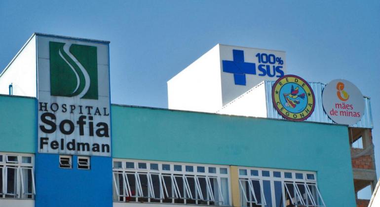 Sofia Feldman recebe doações do Banco de Alimentos da PBH Fachada do Hospital Sofia Feldoman. Há a marca do SUS e do projeto mães de minas.