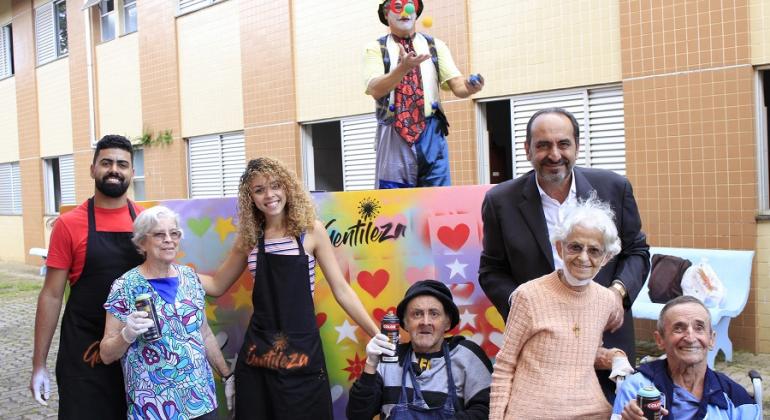 Prefeito Alexandre Kalil com quatro idosos e três auxiliares. 