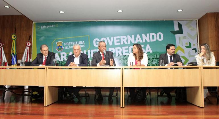 Seminário impulsiona a implementação do MROSC-BH Sentados, da esquerda para a direita os secretários municipais de Esportes e Lazer, Elberto Furtado Júnior, de Cultura, Juca Ferreira, o Procurador Geral do Município, Tomáz de Aquino Resende, a secretária de Assistência Social, Segurança Alimentar e Cidadania, Maíra Colares, o controlador-geral do município, Leonardo Ferraz, da subsecretária de Planejamento, Gestão e Finanças da Secretaria de Educação, Natália Araújo. Ao fundo, banner escrito "Governando para quem precisa"