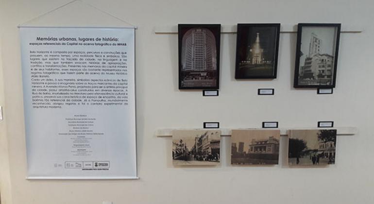 Exposição Memórias Urbanas leva fotografias históricas para várias regiões de BH. Foto: Álvaro Sales/PBH 6 fotografias antigas na parede e banner explicativo sobre a exposição