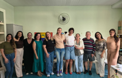 #paratodosverem: Na foto, um grupo de mães de crianças atípicas posa lado a lado em uma sala de escola. Todas sorriem, demonstrando afeto, força e união. O ambiente é iluminado e acolhedor.
