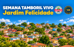 A imagem destaca uma área residencial em meio às árvores e em terreno do tipo encosta. São casas de diversos tipos, tamanhos e cores. Acima das casas, podemos ver um céu azul com poucas nuvens. Nessa parte tem o escrito: SEMANA TAMBORIL VIVO, na cor branca e abaixo JARDIM FELICIDADE, na cor amarela. Ao lado tem dois selos "Fiscalizar - Conscientização - Educar" e "Fiscalização de Belo Horizonte - 128"
