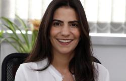 Subsecretária de Modernização da Gestão da Secretaria de Planejamento, Orçamento e Gestão - Renata Coelho, posa em uma fotografia apenas de rosto em local fechado usando uma blusa de cor branca.