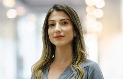 Diretora de Inclusão Digital da Prodabel (DID - PB) - Milla Fernandes Ribeiro Tangari, posa em espaço fechado, usando blusa cinza.