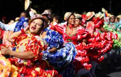 Mulheres vestidas com trajes típicos juninos dançam 